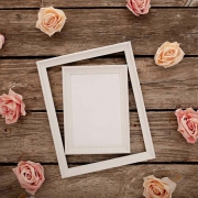 wedding frame with pink roses brown wooden background
