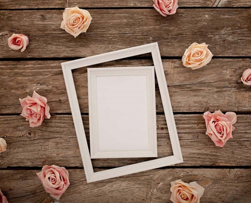 wedding frame with pink roses brown wooden background