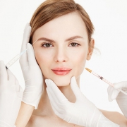 Cosmetologists hands making medical botox injections to beautiful . Skin lifting. Facial treatment. Beauty and spa. Copy space.
