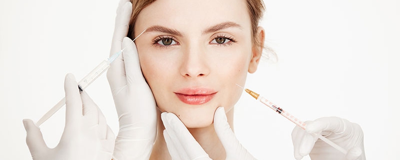 Cosmetologists hands making medical botox injections to beautiful . Skin lifting. Facial treatment. Beauty and spa. Copy space.